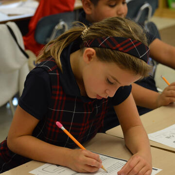 Xavier Elementary student working on homework in classroom