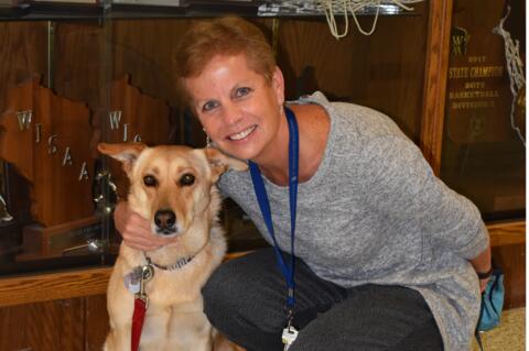 Xavier High School counselor with certified therapy dog, Lady.