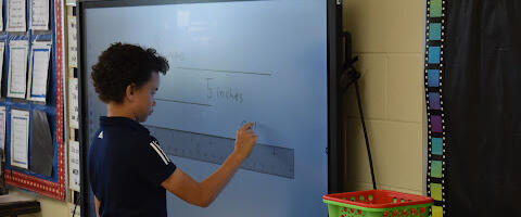 Xavier Elementary student working on BenQ Board